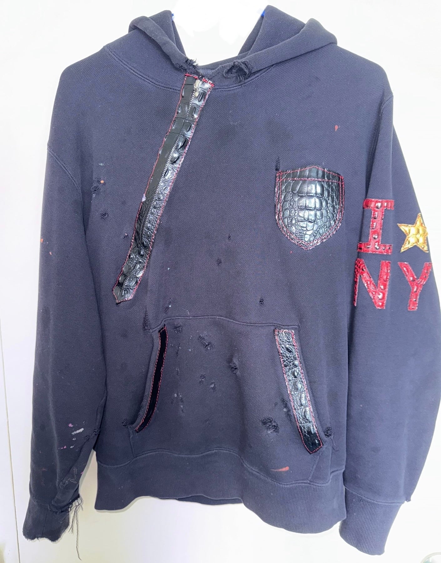 I Star in NY Hoodie showcasing vegan leather accents and a unique distressed design.